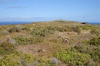 Punt van het eiland Ilhéu Chão. In de verte is de vuurtoren zichtbaar