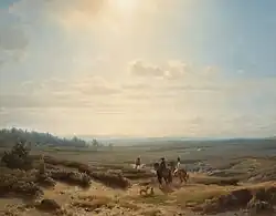 Ruiters in een weids landschap