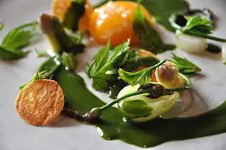 Witte asperge met eierdooier en een saus van lievevrouwebedstro