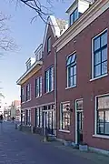 Winkelwoonhuis met voorgevel in sobere traditionalistisch-classicistische bouwtrant, in opzet mogelijk 17de-eeuws of ouder. Het is van belang als goed en gaaf voorbeeld van een winkelpand met een voorgevel in traditionalistisch-classicistische vormen.