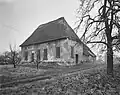 Gepleisterde boerderij op T-vormige plattegrond. Het woonhuis heeft een hoog rieten schilddak, de dwars daarachter gebouwde stal heeft een rieten dak met overstek aan de achterzijde