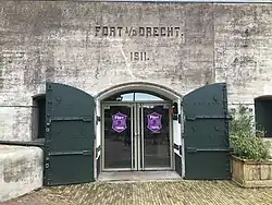 De poternedeur met naam en bouwjaar van het fort