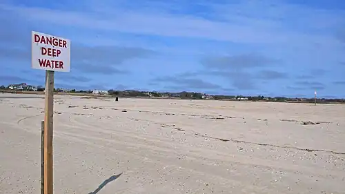 Hoogwater-waarschuwingsbord op het strand