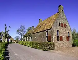 Vooraanzicht van de herbouwde kosterij.