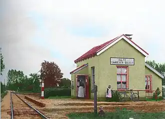 Ingekleurde foto van de stopplaats rond 1900.