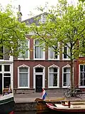 De Flappe, pand met lijstgevel met stucversieringen. Vier vensterassen breed.