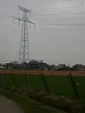 De twee grote hoogspanningslijnen zijn een vertrouwd zicht in het gehucht.