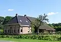 Langhuisboerderij met jugendstil-achtige decoratie in kalkzandsteen[1]