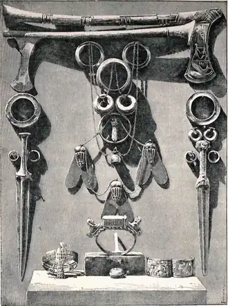 Ceremonieel wapentuig en juwelen van Ahhotep I Luxor Museum (ca. 1901) Tekening van Gaston Maspero Vindplaats graftombe van Ahhotep I Met o.a. een bijl met Ahmose I die een Hyksos strijder neerslaat, en gouden vliegen van eer aan de koningin toegekend wegens haar rol bij het verslaan van de Hyksos