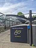 Rij fietskluizen met OV-fietsen bij Station Breda-Prinsenbeek.