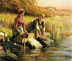 Washing clothes by a stream