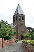 Toegang tot de kerk tussen de muren van de aanpalende eigendommen.