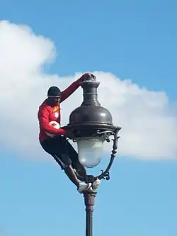 Op een lantaarnpaal klimmen voor de Sacré-Cœur