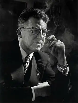 C.J.M. Mol, arts en KVP kamerlid thuis een sigaar rokend. Etten, Nederland, 18 februari 1956.