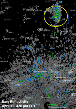 Op deze afbeelding van een weerradar is bovenaan in de gele cirkel een artefact zichtbaar: een reflectie die niet door een bui komt maar door een windturbine.