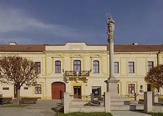 Vooraanzicht van het paleis (detail). Aan het hoogste punt van de gevel werd een inscriptie aangebracht.