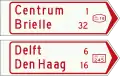 K7: Wegwijzer voor fietsers en bromfietsers (handwijzer), met lokaal doel, interlokaal doel, stedelijk fietsroutenummer (boven), en met interlokale doelen en interlokaal fietsroutenummer (onder)[20]