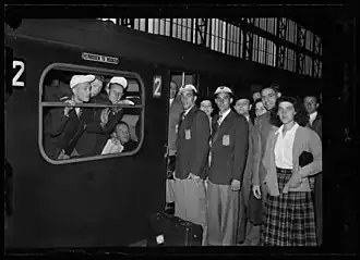 Nederlandse wielrenners voor vertrek naar de Olympische Spelen in Londen, 1948. Joop Harmans en Jan Hijzelendoorn vanachter het raam, Piet Peters en Gerrit Voorting op het perron.