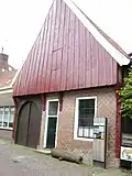 Saksische hoeve met stijl- en regelwerk en hoge houten puntgevel met gesneden topmakelaar. Thans in gebruik als Grols Museum