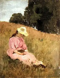 Lezend meisje op een weide