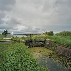 Haanssluis voor de restauratie (2005) met op de achtergrond de uitstroom van de Haansvaart in het Schildmeer.