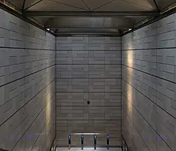 De wanden rond de roltrappen.