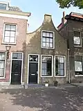 Huis met tuitgevel met in de zolderverdieping roeden