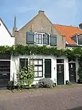 Huis met puntgevel met vlechtingen met ramen stijl