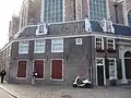 Om een portaal naar de oudekerk tegen deze kerk aangebouwd dwarshuis