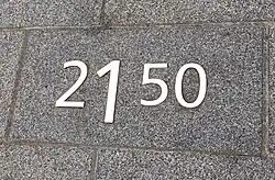 Roestvaststalen cijfers op diverse stoeptegels.