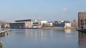 Gezicht op de voormalige Figee-fabriek aan het Spaarne, tegenwoordig kantoorunits. Rechts valt de oude Drostefabriek te zien.