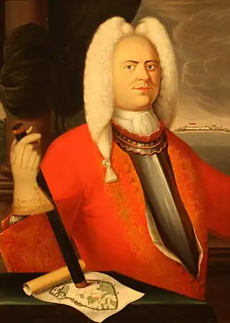 Gouverneur Versluys' commandostaf rust op een kaart van Ceylon en rechts in de verte is Fort Colombo.