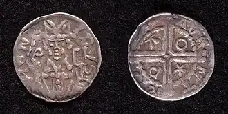 Zilveren penning of denarius (diameter 13 mm) van Hendrik van Vianden als bisschop van Utrecht, geslagen kort na 1250, muntplaats Deventer. De voorzijde toont een gemijterd borstbeeld van de bisschop met staf en missaal. Omschrift: HENR-ICVS. De keerzijde toont een lang kruis met */P/A/O in de kwartieren, omschrift: + D-AVE-NT-RIA.