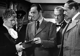 Scène uit Terror by Night met (v.l.n.r.) Mary Forbes, Billy Bevan, Alan Mowbray, Basil Rathbone, Nigel Bruce en Dennis Hoey
