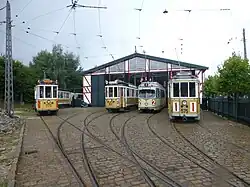 Drie Kopenhagense trams: motorwagen 275, 437 en 575 naast gelede wagen 2412 uit Düsseldorf voor de Valby Gamle Remise; 31 augustus 2013.