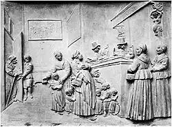 Inschrijving der bedeelden, zandstenen reliëf