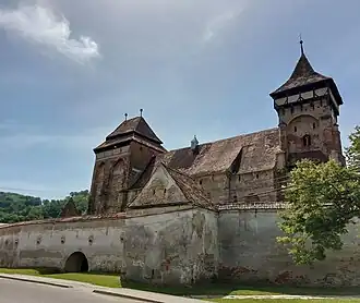 Foto van de weermuur om de kerk heen, de kerk toont er bovenuit