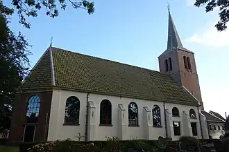Kerk, spuithuisje en toren gezien vanaf de begraafplaats